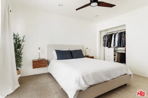 a bedroom with a bed and wall painting
