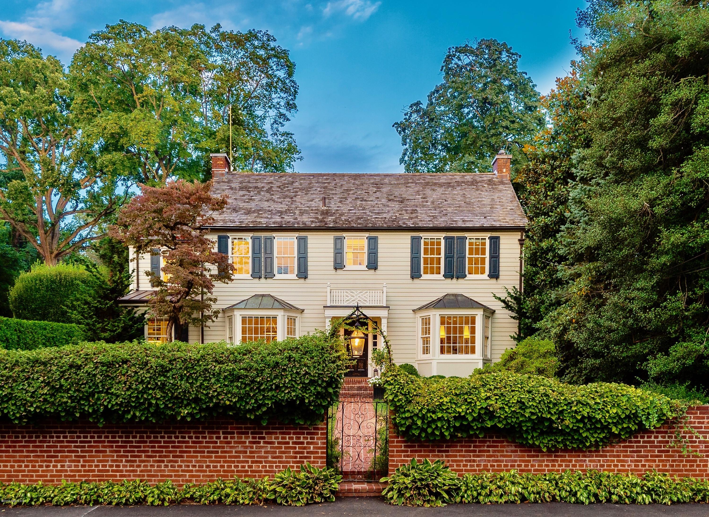 23 Maher Avenue Greenwich, CT 06830 - Photo 2 of 51 a front view of a house with a yard and garage