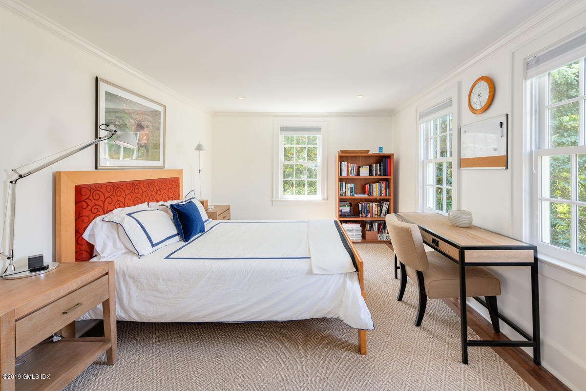 23 Maher Avenue Greenwich, CT 06830 - Photo 29 of 51 a bedroom with a bed and a table in it