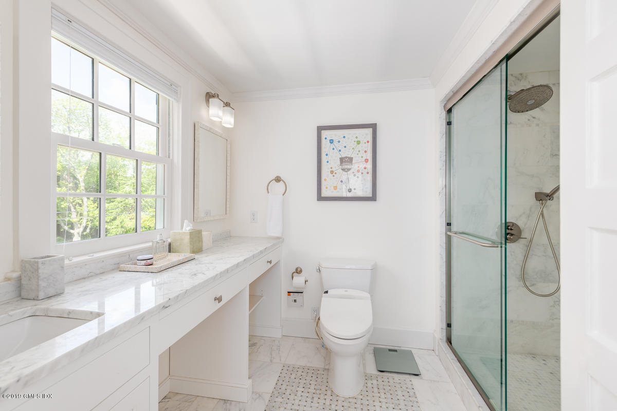23 Maher Avenue Greenwich, CT 06830 - Photo 30 of 51 a bathroom with a granite countertop sink toilet a large mirror and a window