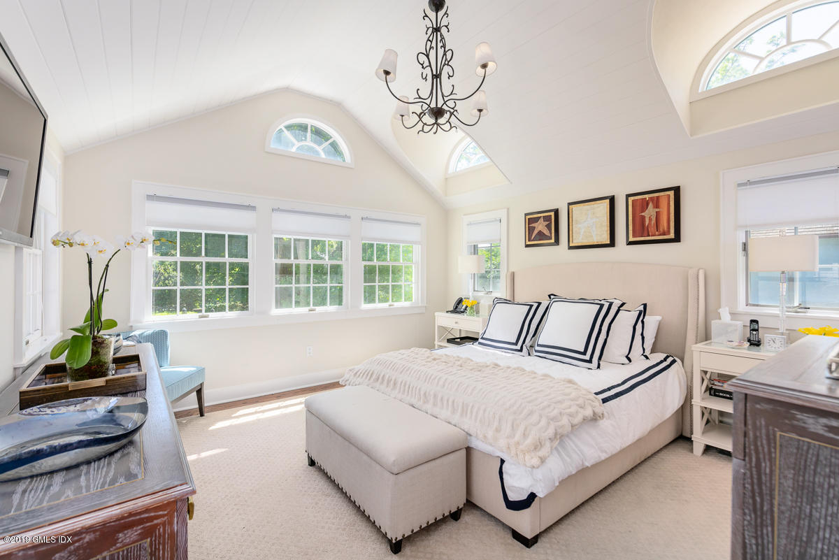 23 Maher Avenue Greenwich, CT 06830 - Photo 32 of 51 a spacious bedroom with a large bed couch and a window