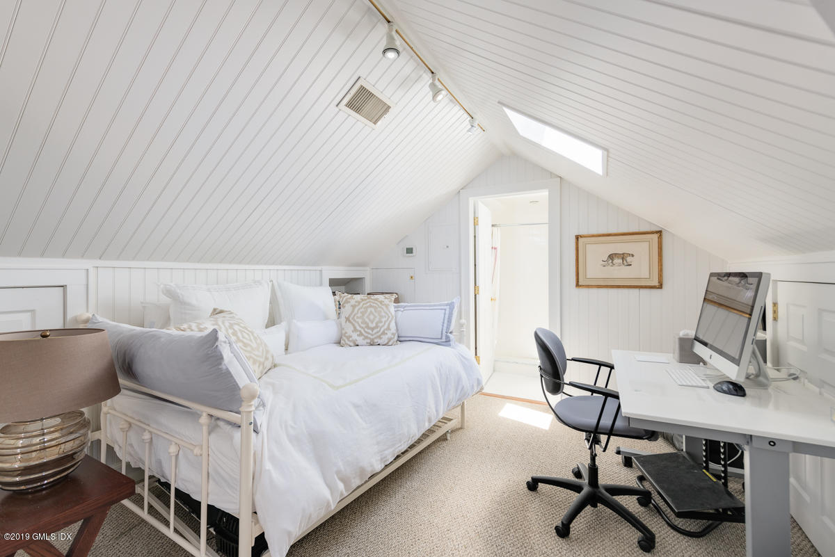 23 Maher Avenue Greenwich, CT 06830 - Photo 36 of 51 a bedroom with a bed a desk and chair