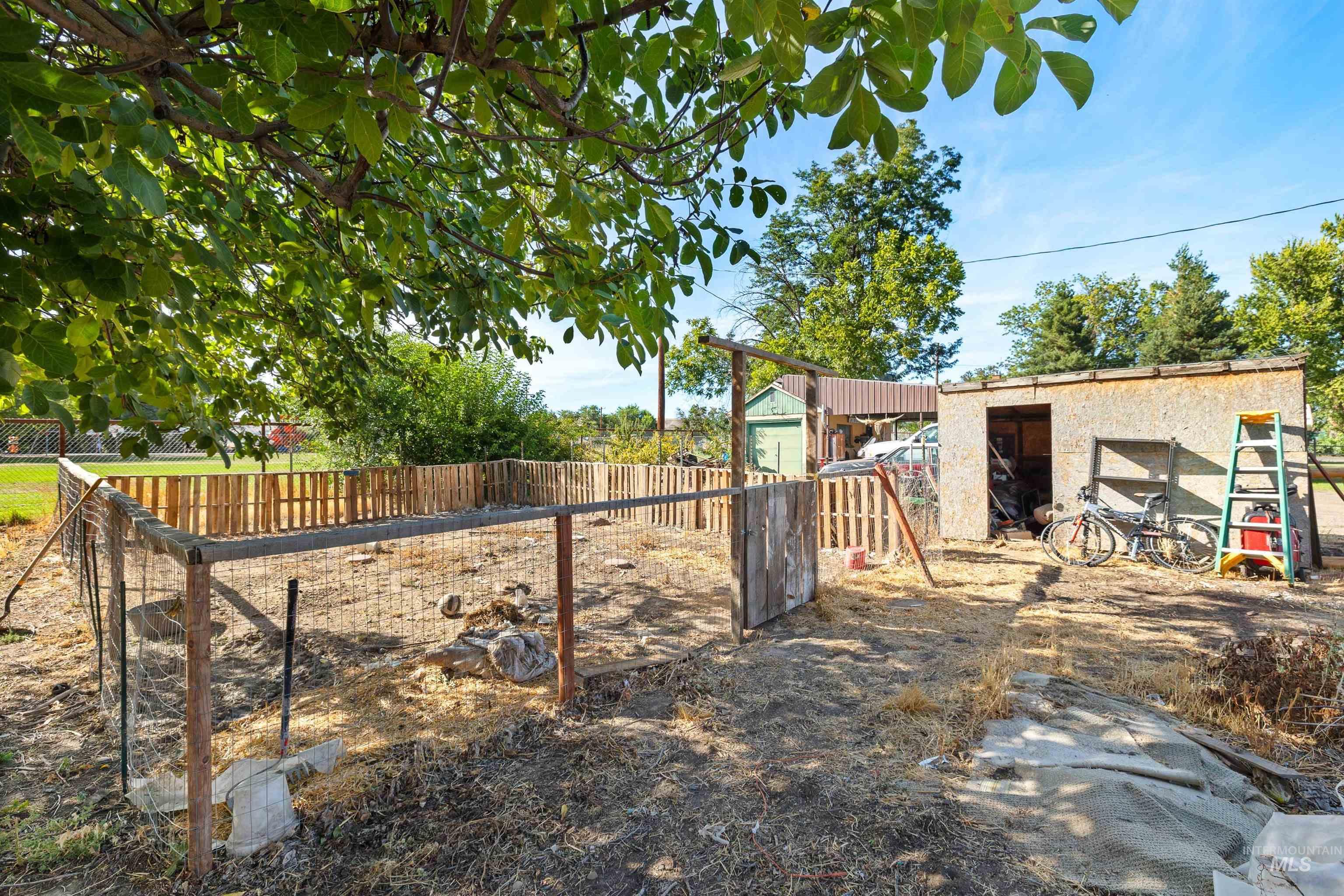131 West Spring Street Hagerman, ID 83332 - Photo 14 of 25 Enclosed yard space featuring a wood-panel fence and a detached storage shed