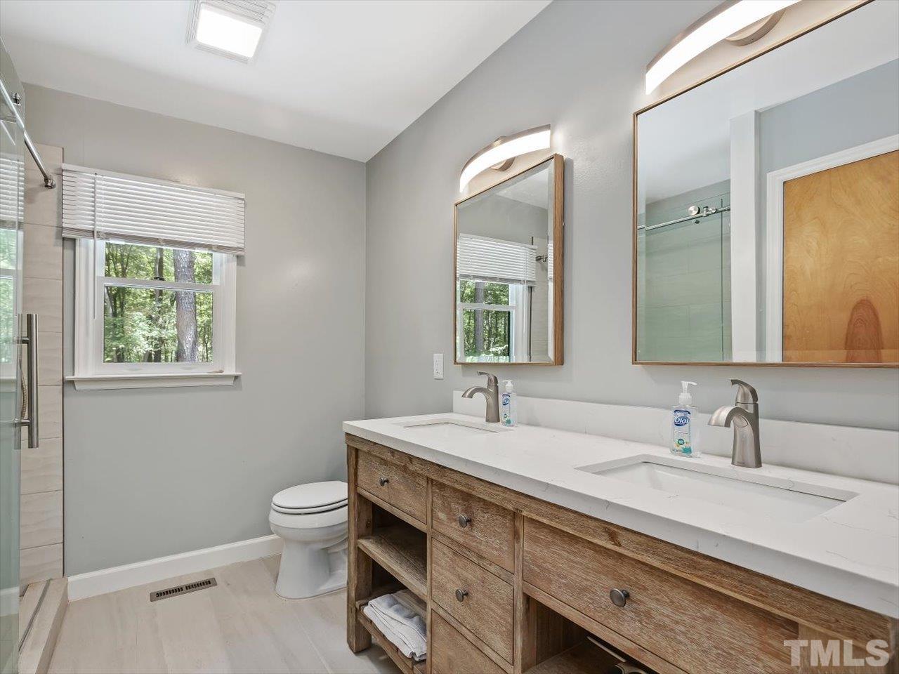 261 Ridge View Pittsboro, NC 27312 - Photo 15 of 57 a bathroom with a double vanity sink toilet and a mirror