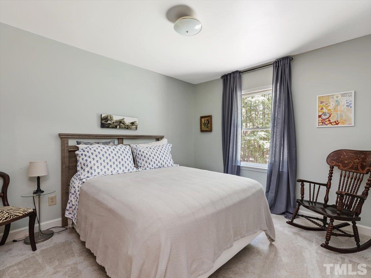 261 Ridge View Pittsboro, NC 27312 - Photo 18 of 57 a bedroom with a bed a chair and next to a window