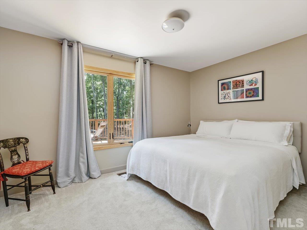 261 Ridge View Pittsboro, NC 27312 - Photo 22 of 57 a bedroom with a bed and a chair