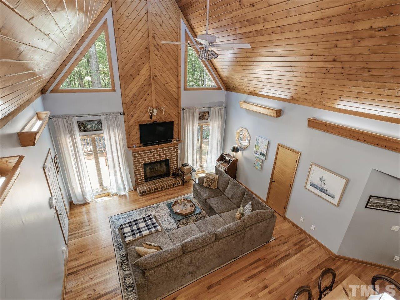 261 Ridge View Pittsboro, NC 27312 - Photo 30 of 57 a living room with furniture a flat screen tv and a fireplace