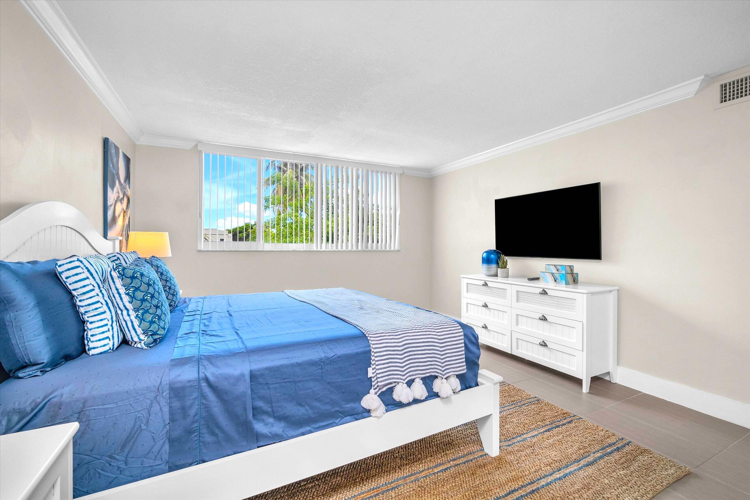 601 North Ocean Boulevard, Unit 203 Boca Raton, FL 33432 - Photo 16 of 20 a living room with furniture and flat screen tv