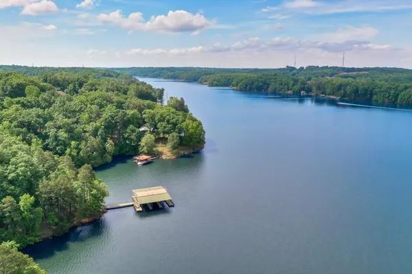 a wooden bench sitting in the middle of a lake