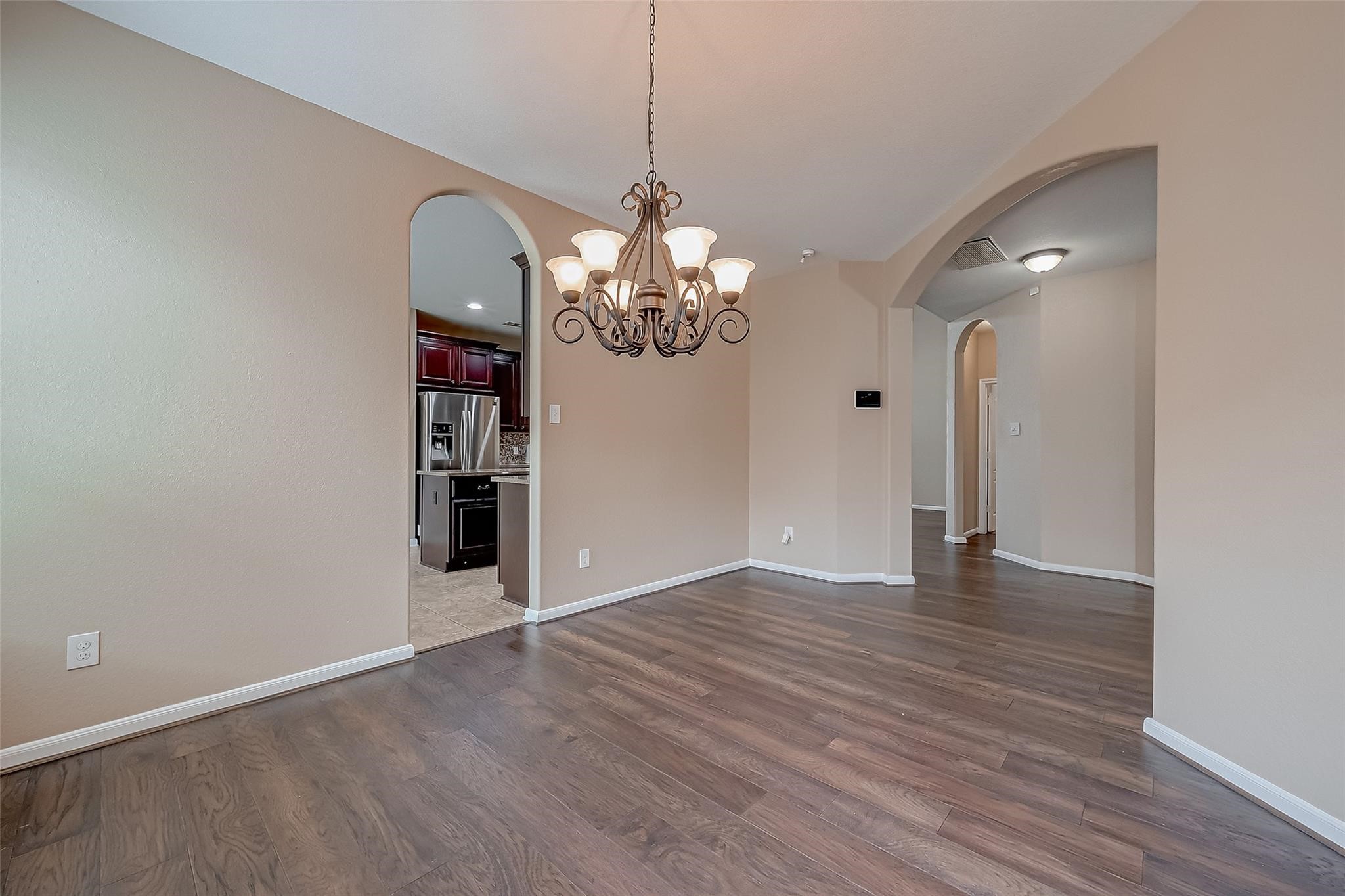21831 Mount Hunt Drive Spring, TX 77388 - Photo 11 of 47 a view of an empty room with wooden floor and chandelier