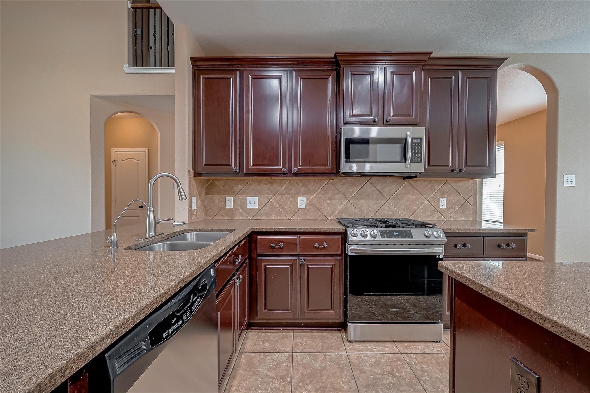 21831 Mount Hunt Drive Spring, TX 77388 - Photo 20 of 47 a kitchen with stainless steel appliances granite countertop a sink stove and refrigerator