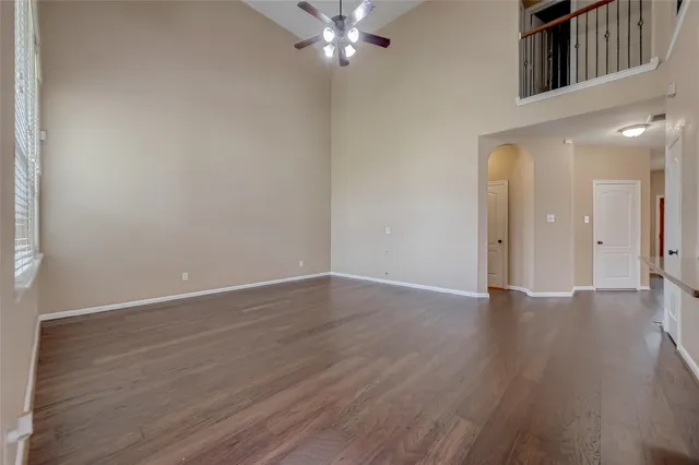 a view of an empty room with wooden floor