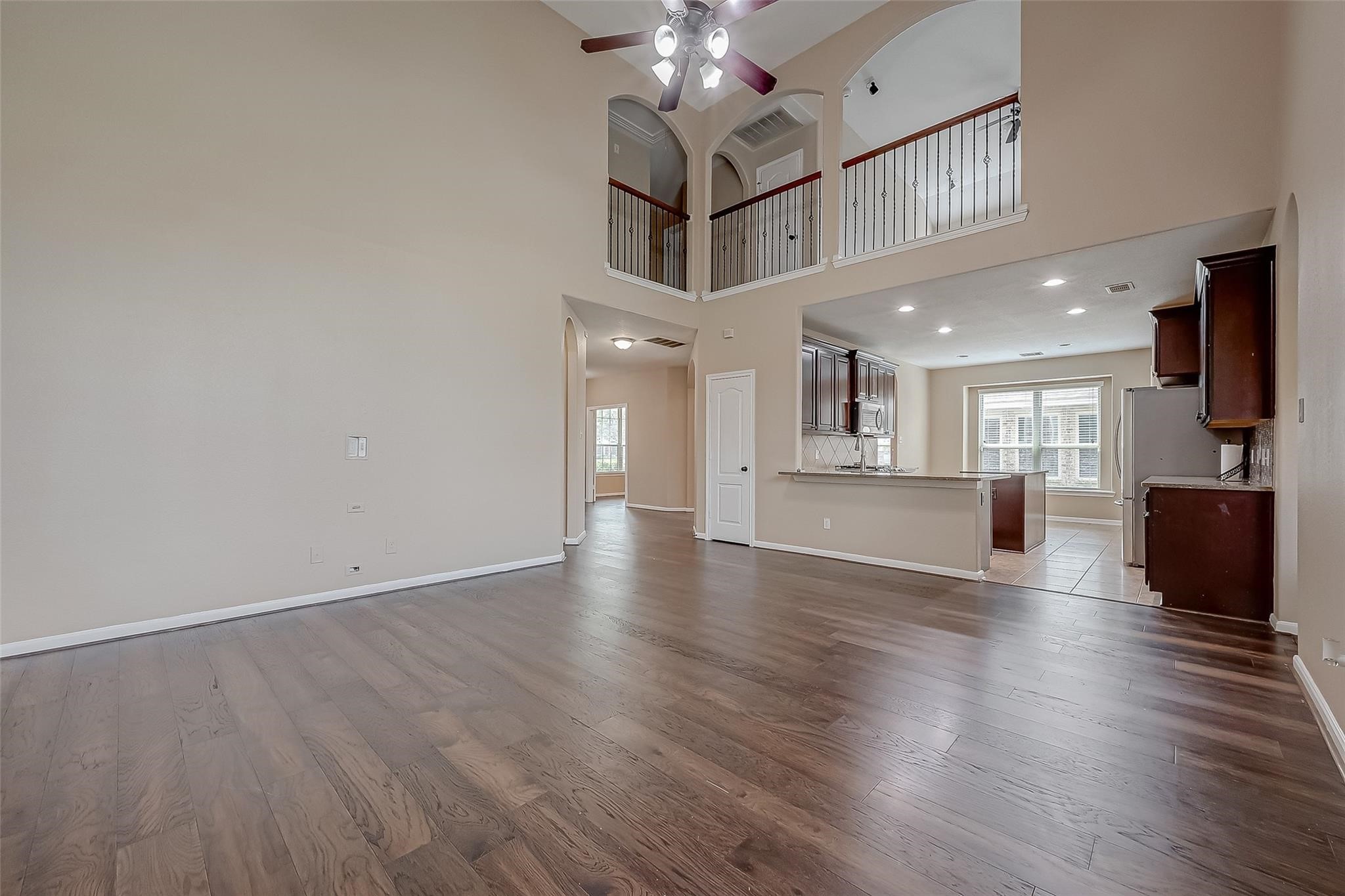 21831 Mount Hunt Drive Spring, TX 77388 - Photo 24 of 47 a view of a kitchen and an empty room with wooden floor kitchen view