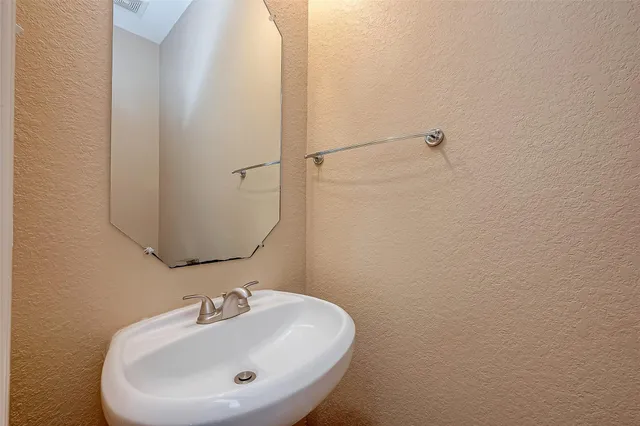 a bathroom with a sink and mirror