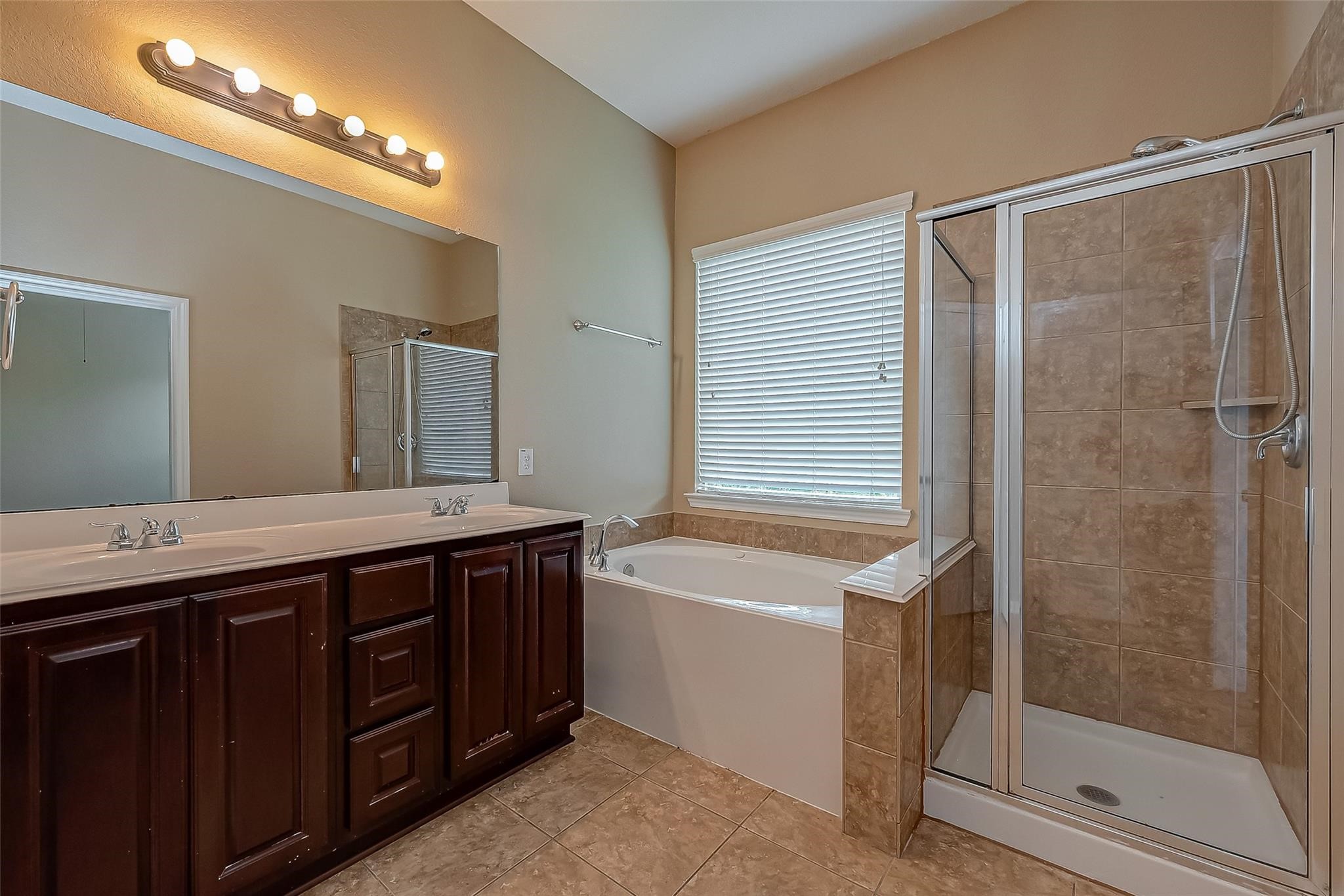 21831 Mount Hunt Drive Spring, TX 77388 - Photo 32 of 47 a spacious bathroom with a granite countertop sink mirror and shower