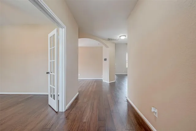 a view of a hallway with wooden floor