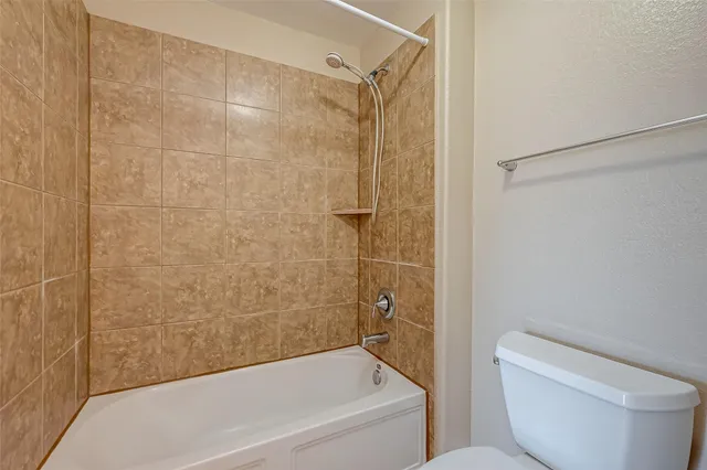 a bathroom with a toilet and a bathtub