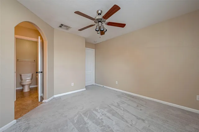 wooden floor in an empty room and a bathroom