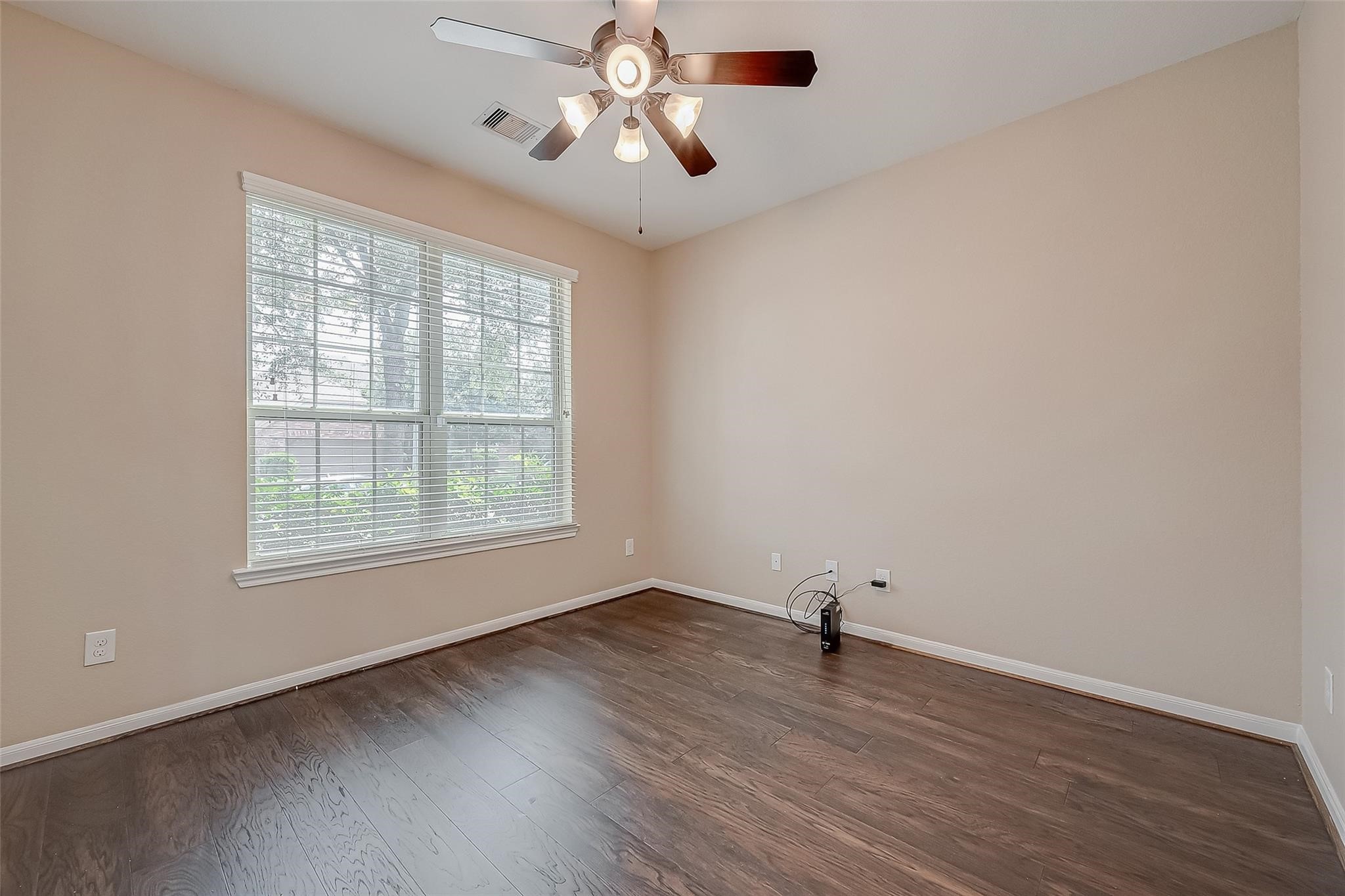 21831 Mount Hunt Drive Spring, TX 77388 - Photo 6 of 47 a view of an empty room with wooden floor and a window