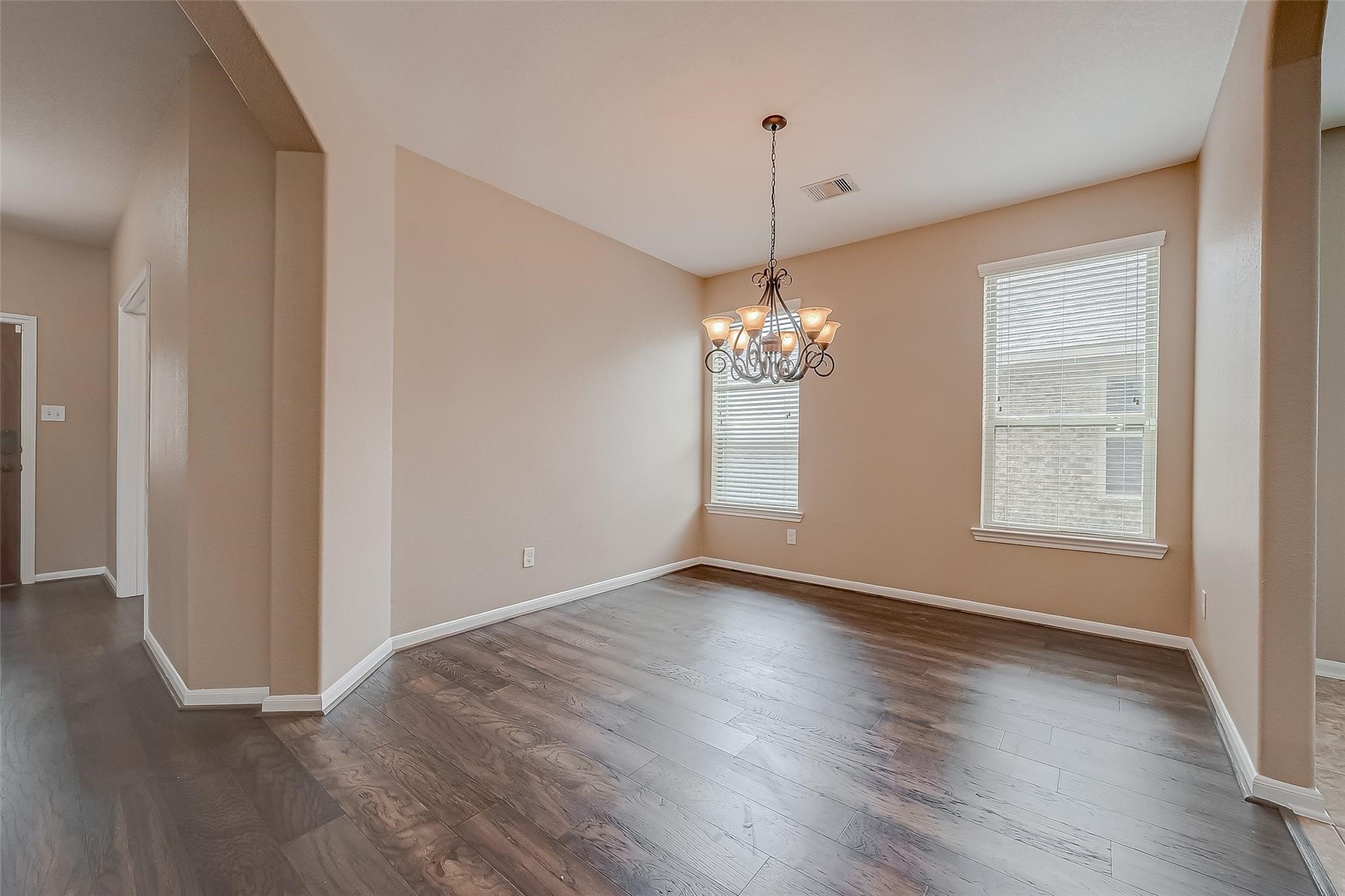 21831 Mount Hunt Drive Spring, TX 77388 - Photo 9 of 47 an empty room with wooden floor chandelier and window