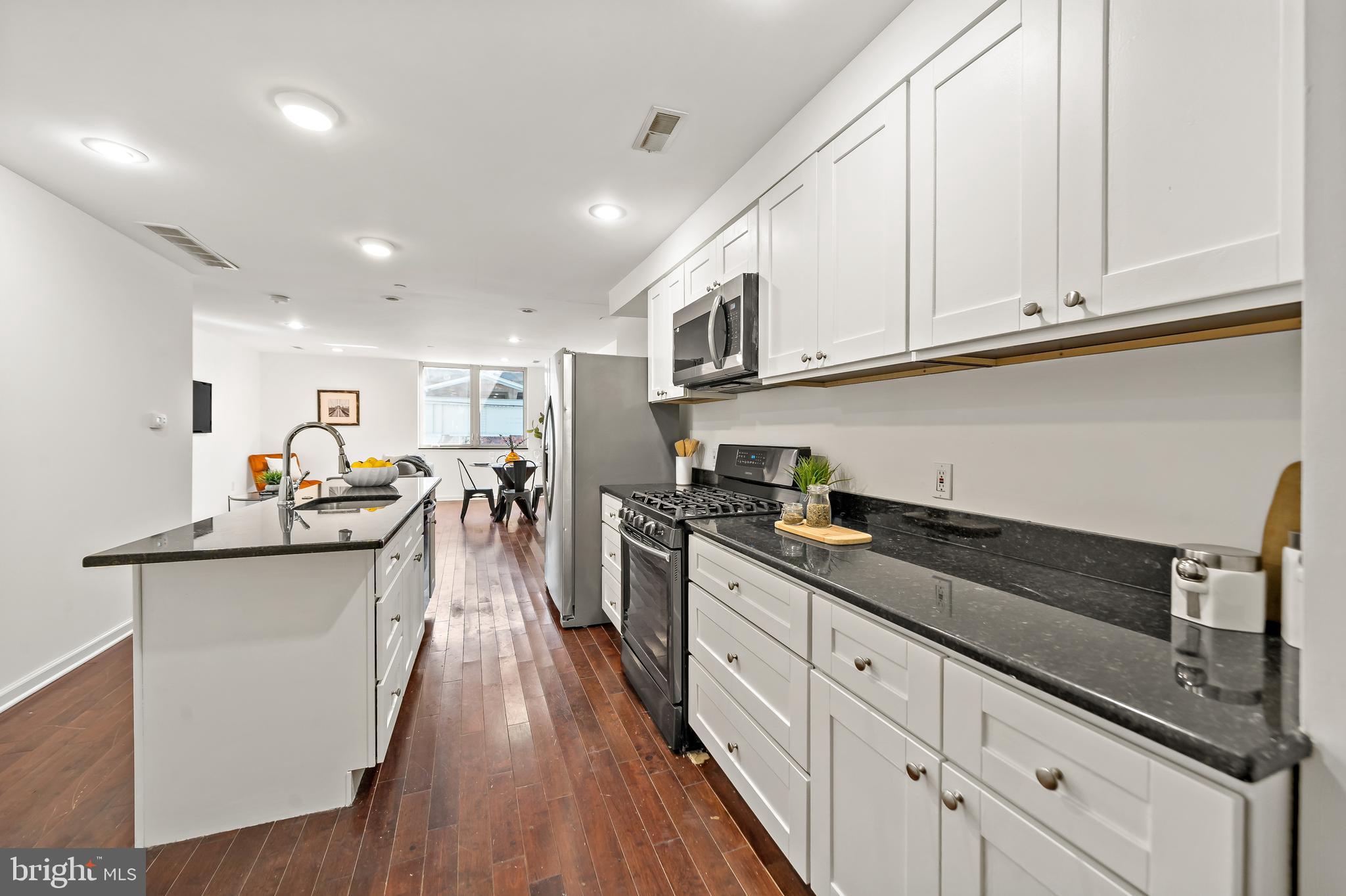 1816 North Front Street, Unit B Philadelphia, PA 19122 - Photo 6 of 19 a kitchen with white cabinets and sink