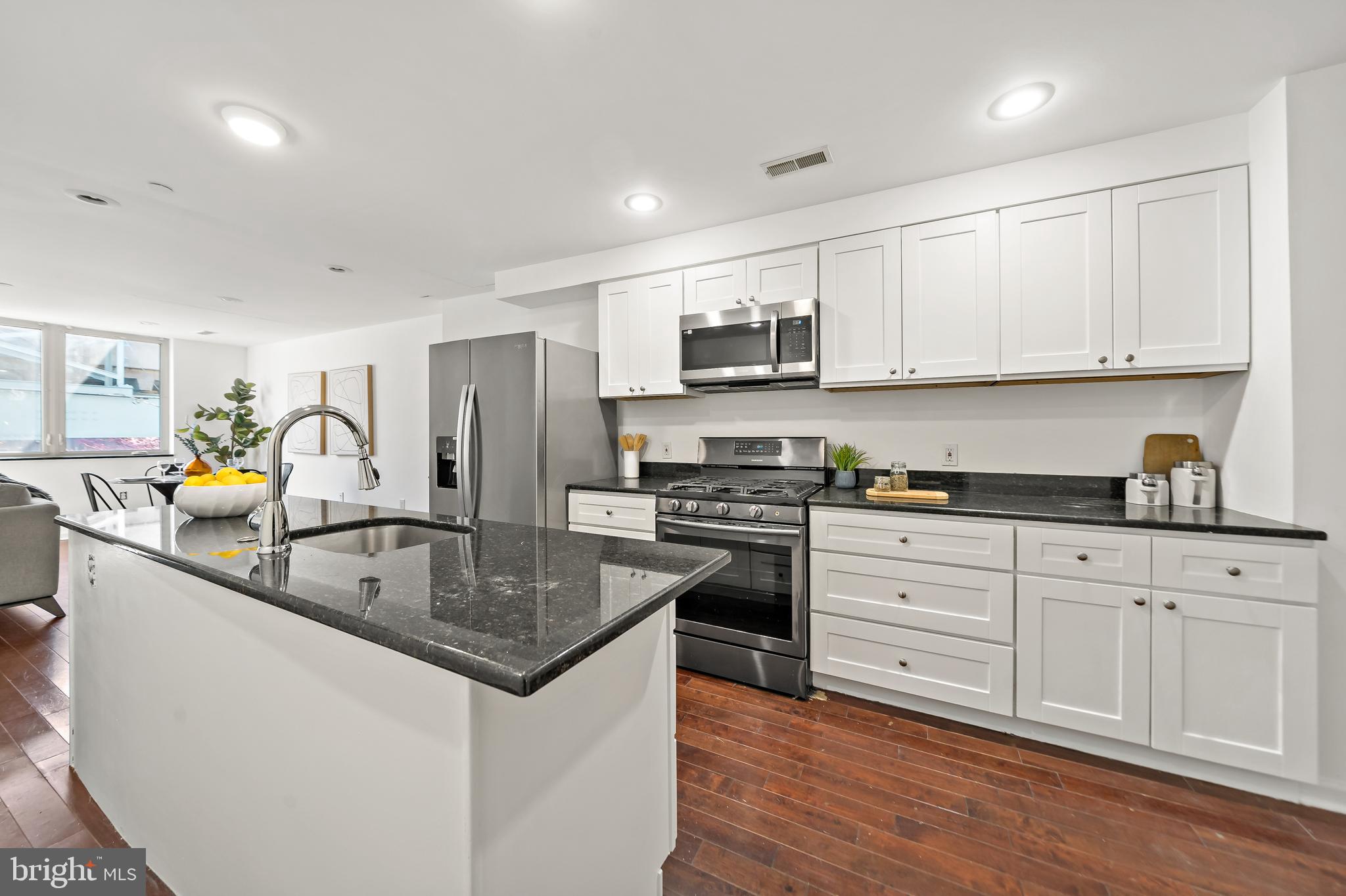 1816 North Front Street, Unit B Philadelphia, PA 19122 - Photo 7 of 19 a kitchen with stainless steel appliances granite countertop a sink stove and refrigerator
