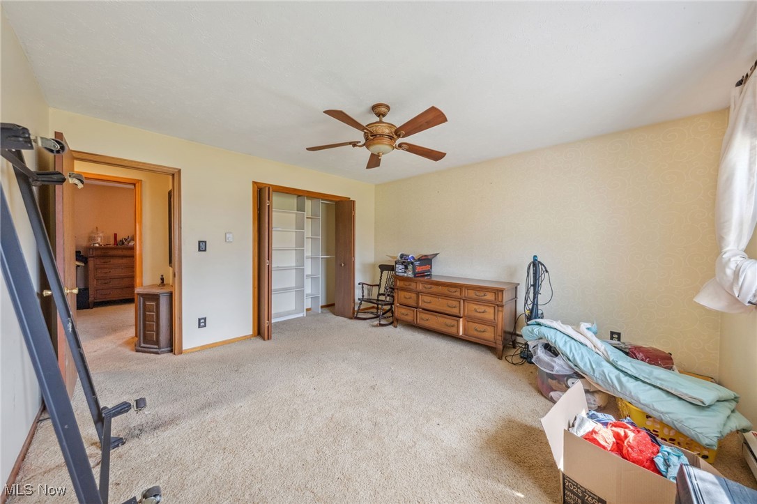 4790 Paradise Road Seville, OH 44273 - Photo 32 of 45 Carpeted bedroom with a ceiling fan, baseboards, and a closet