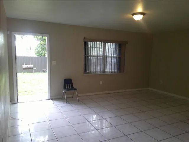 a view of a livingroom with an empty space and a window
