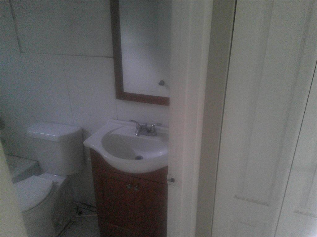 Undisclosed Address Opa-Locka, FL 33054 - Photo 7 of 9 a bathroom with a sink toilet and a mirror