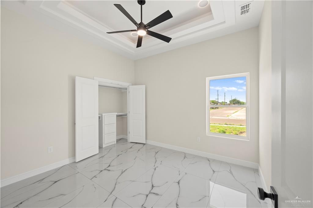 801 Falcon Street Rio Grande City, TX 78582 - Photo 14 of 36 an empty room that has a window and a ceiling fan