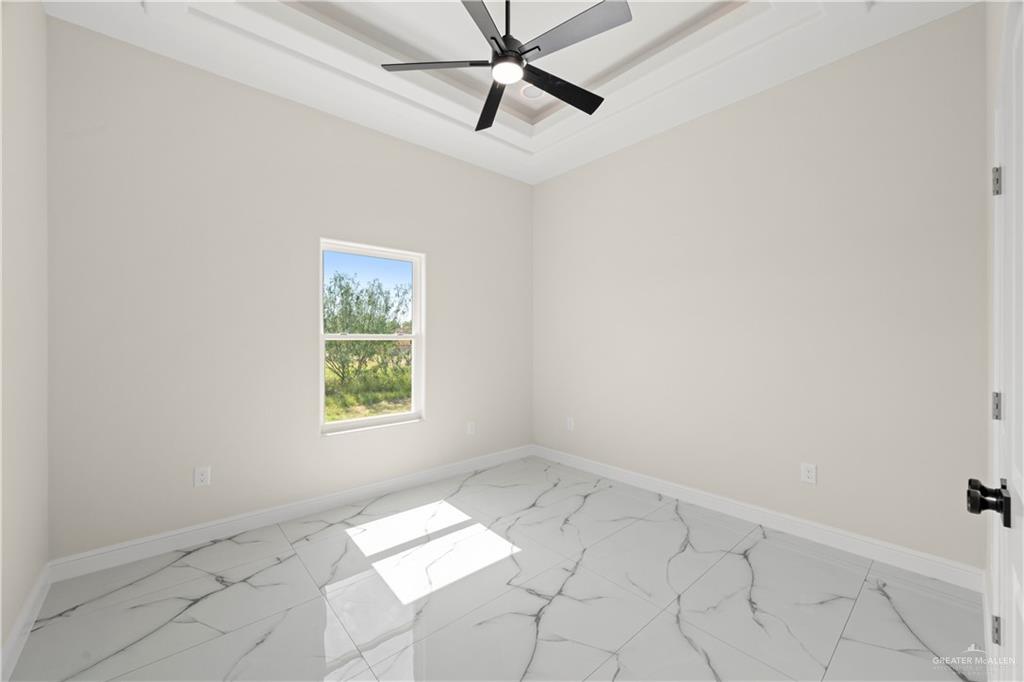 801 Falcon Street Rio Grande City, TX 78582 - Photo 15 of 36 an empty room with windows and fan