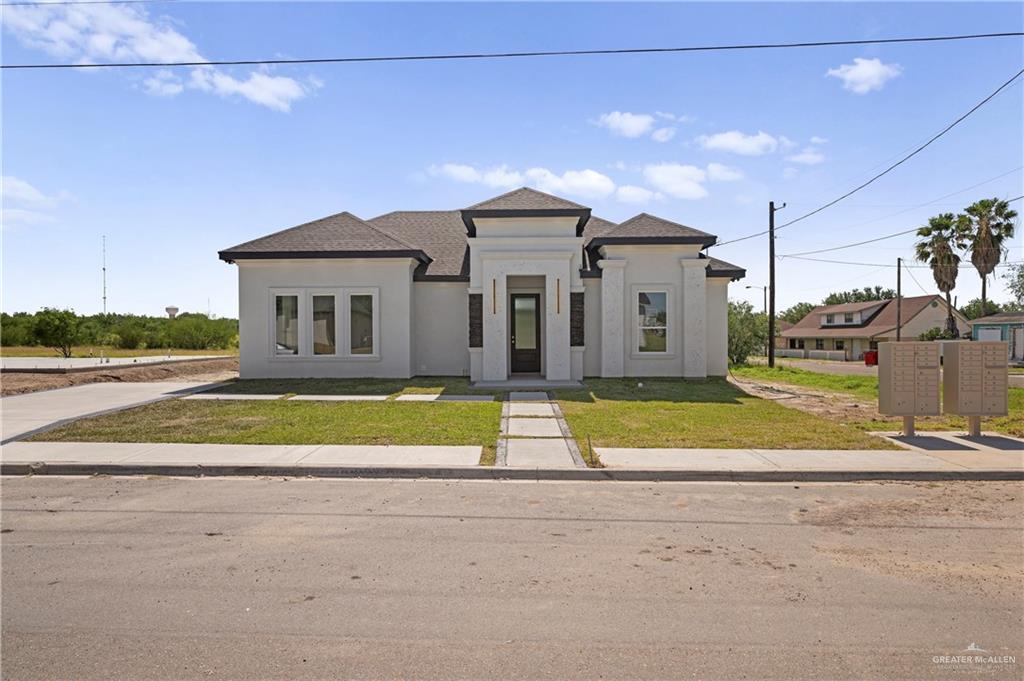 801 Falcon Street Rio Grande City, TX 78582 - Photo 2 of 36 a view of a house with a big yard and palm trees