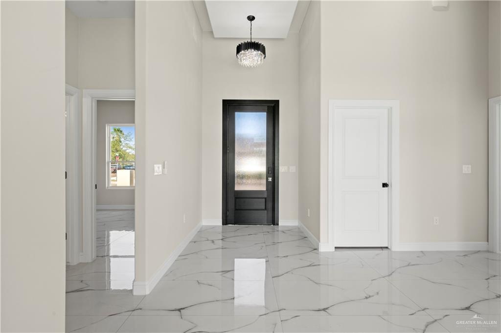 801 Falcon Street Rio Grande City, TX 78582 - Photo 10 of 36 a view of a hallway to an entryway with wooden floor