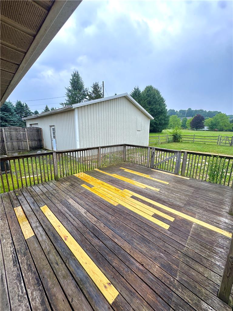 8325 Schantz Road Breinigsville, PA 18031 - Photo 20 of 21 An inviting deck extends from the home, offering views of the yard and surrounding landscape.