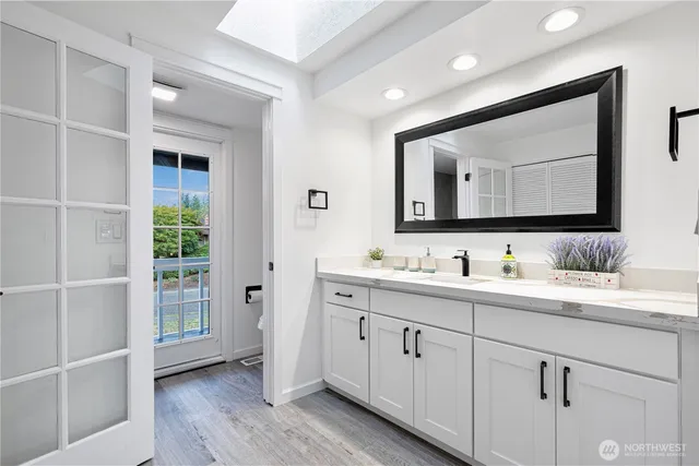 a bathroom with a double vanity sink and mirror