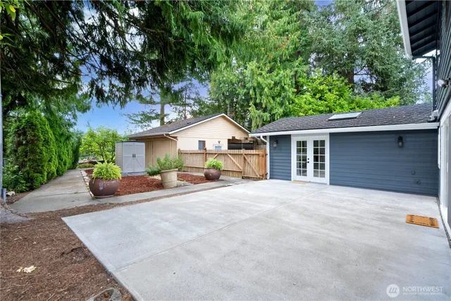 a view of a house with a yard and potted plants