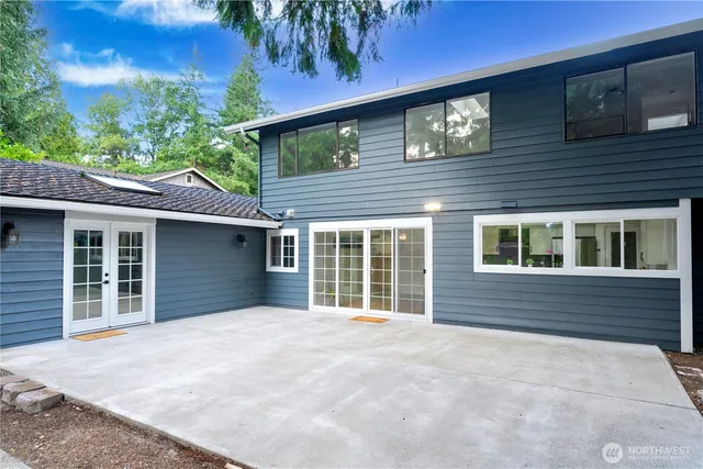 a view of a house with a yard and potted plants