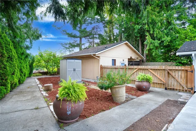 a view of a house with a small yard and a garage