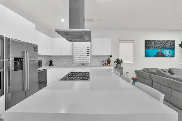 a kitchen with stainless steel appliances granite countertop a sink and a stove