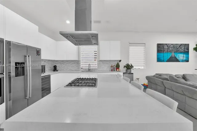 a kitchen with stainless steel appliances granite countertop a sink and a stove