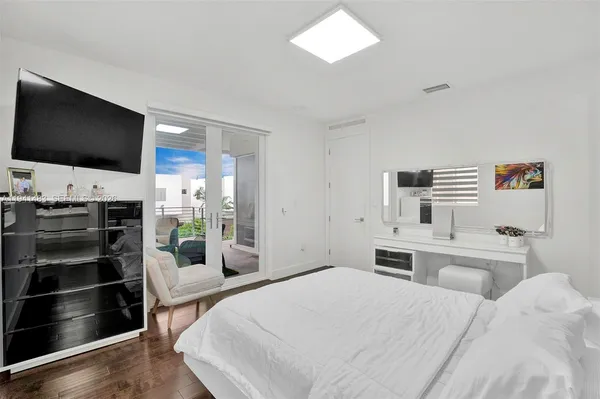 a bathroom with a toilet sink vanity granite and shower