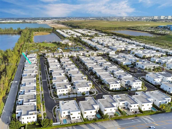 a palm tree sitting in front of a house with a yard