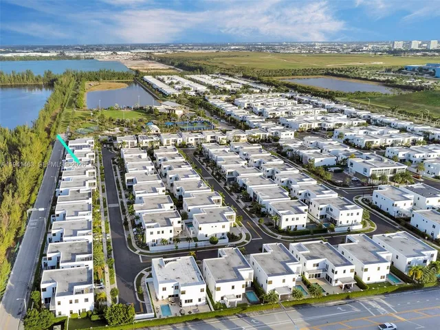 a palm tree sitting in front of a house with a yard
