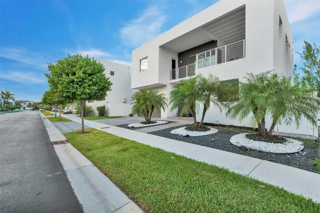 a view of a hallway with wooden floor and a dining room