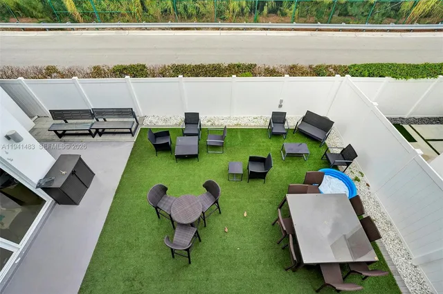 a view of an chairs and table in patio