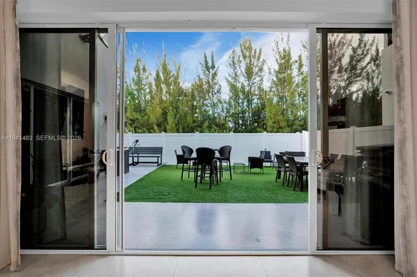 a view of an outdoor dining space with a table and chairs
