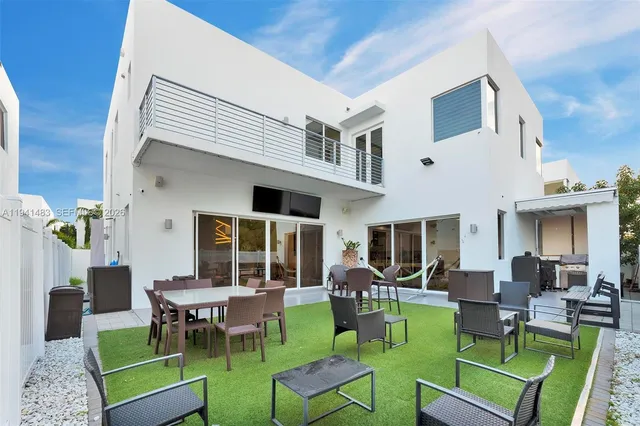 a view of outdoor space with barbeque grill and brick wall in front of it