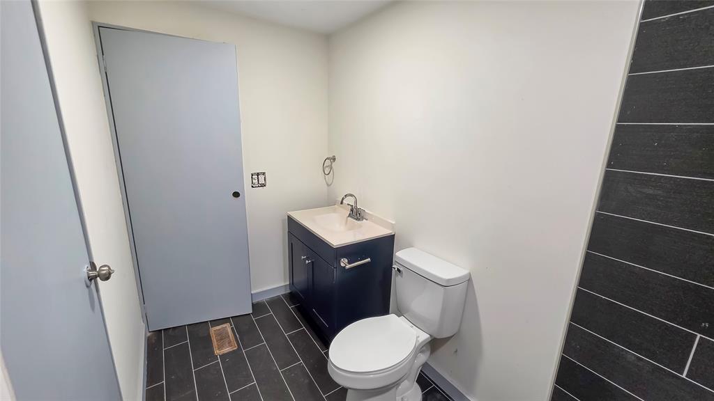 111 Custer Mabank, TX 75156 - Photo 11 of 20 a white toilet sitting next to a sink and vanity