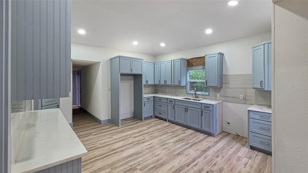 111 Custer Mabank, TX 75156 - Photo 4 of 20 a kitchen with stainless steel appliances granite countertop a refrigerator a sink dishwasher a stove and white countertops with wooden floor