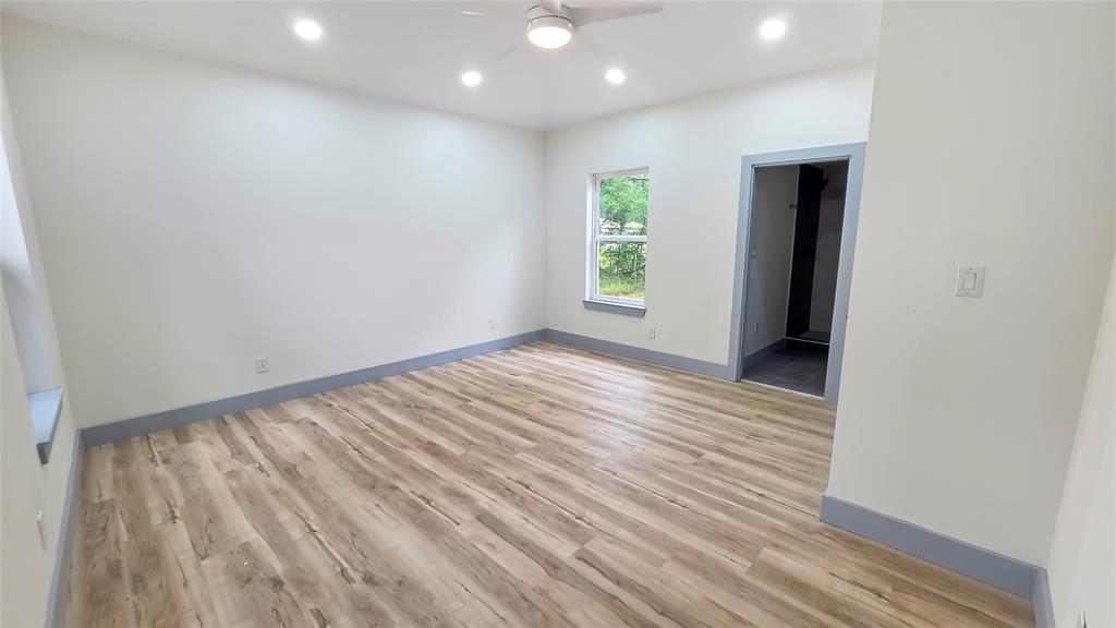 111 Custer Mabank, TX 75156 - Photo 6 of 20 an empty room with wooden floor and windows